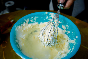 blue bowl with ice cream and whisk