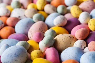 Fototapeta na wymiar Easter background with colorful chocolate eggs