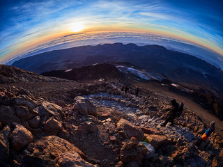 Beautiful view from the top of the Teide volcano peak, Pico del Teide, with tourists at sunrise in Tenerife, Spain