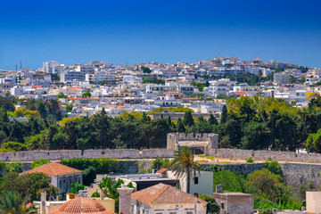 Fototapeta na wymiar The new city of Rhodes, with luxurious houses, developed on the hills above the old city and outside the ancient stone defensive walls, also near the Acropolis. Popular summer holiday destination.