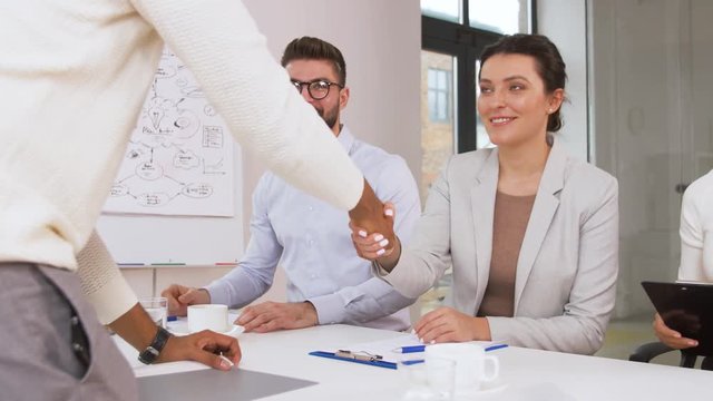 job, hiring and employment concept - international team of recruiters having interview with asian female employee at office