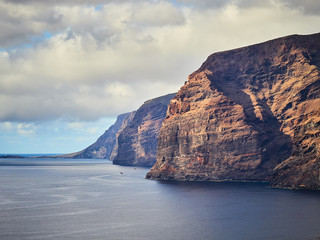 Fototapeta na wymiar Panoramic view of the beautiful rocky coast Los Gigantes on Tenerife, Los Gigantes beach