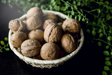 walnuts in a basket on a black background