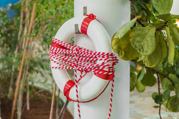White and white Life buoy, all Water rescue emergency equipment at swimming pool