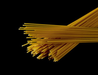 Spaghetti, yellow pasta isolated on black background, clipping path
