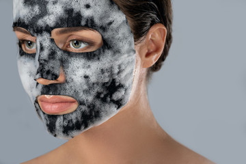 Woman with  bubble sheet mask on her face