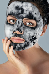 Woman with  bubble sheet mask on her face
