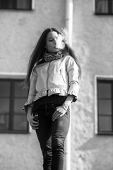 Vape teenager. Young pretty white girl in casual clothing smoking an electronic cigarette in front...