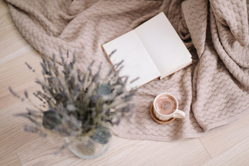 lavender bouquet with book and cup of coffee on wooden background. spring concept. top view. flatlay