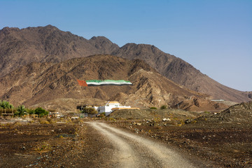 UAE flag on a desert mountain rock