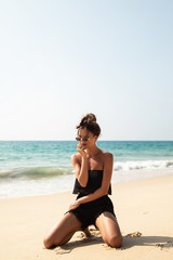 Fototapeta na wymiar Stylish and beautiful woman on the beach