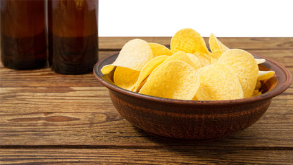 potato chips on empty wooden table isolated on white background copy space