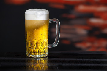 Glass of beer on the dark background