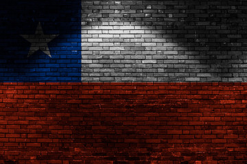 Chile flag on brick wall at night