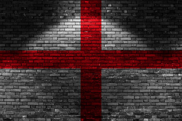 England flag on brick wall at night