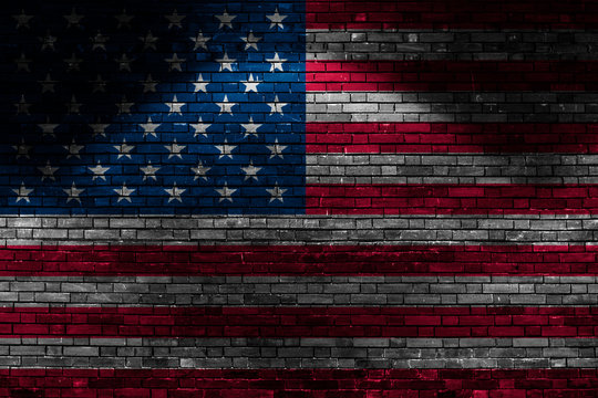 USA flag on brick wall at night