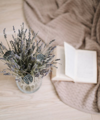 Still life with a bouquet of lavender and a book on wooden background. Provence and rustic style, top view, flatlay 