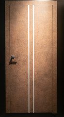 closed room door in brown color with two thin white stripes in dim light