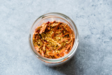 Dried Chili Pepper Flakes and Seeds in Glass Bowl.