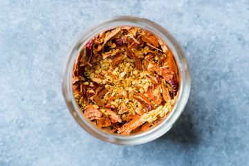 Dried Chili Pepper Flakes and Seeds in Glass Bowl.