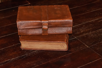 Ancient leather books on a old wooden table