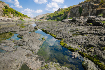 Abrasive basalt rocks at the bottom of the Arda River behind the Studen Kladenets dam, Bulgaria