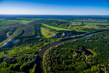 Fototapeta na wymiar The river flows through the valley. Beautiful landscape. Aerial view. The bend of the river. Panorama. River landscape. Drone photography