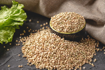 Croup green buckwheat on a dark background. Vegan nutritious and healthy product. Concept of organic food