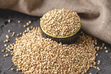 Croup green buckwheat on a dark background. Vegan nutritious and healthy product. Concept of organic food