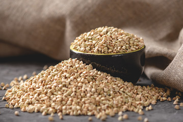 Croup green buckwheat on a dark background. Vegan nutritious and healthy product. Concept of organic food