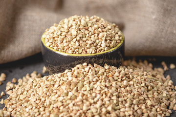 Green buckwheat on a dark background. Vegan nutritious and healthy product. Concept of organic food