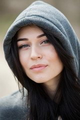 Beauty fashion portrait of young beautiful brunette girl with long black hair and green eyes. Beauty portrait of female face with natural skin.