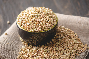 Green buckwheat on a dark background. Vegan nutritious and healthy product. Concept of organic food