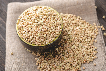 Green buckwheat on a dark background. Vegan nutritious and healthy product. Concept of organic food