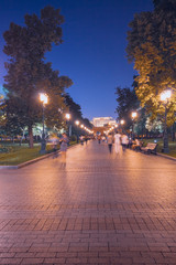 Alley in the Alexander Garden in Moscow in the evening people walking in the park