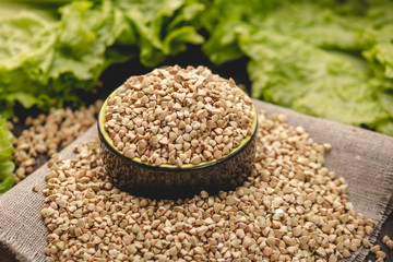 Seeds green buckwheat on a dark background. Vegan nutritious and healthy product. Concept of organic food