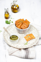 A bowl with crispy cheese crackers on white background