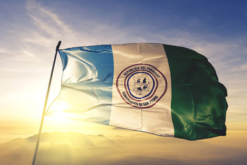 San Pedro department of Paraguay flag waving on the top sunrise mist fog