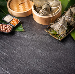Close up, copy space, top view, famous asian chinese tasty handmade food in dragon boat(duan wu) festival, steamed rice dumplings shaped pyramidal by leaves ingredients