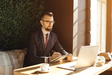 Young handsome businessman conducting negotiations with investors. Electronic business. Alternative...