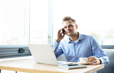 Stylish young man calling by the phone to solve business problems. Online consultation by phone....
