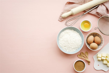 Baking ingredients and utensils on pink background. Cooking or baking cake, cookies, pastry...