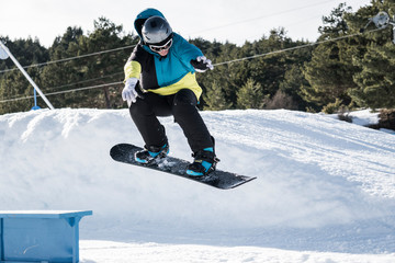 snowboarder jumps end grind