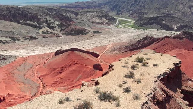 Flying over red rocks at the foothills of Andes mountains in Quebrada de Las Flechas valley near Salta, Argentina. Aerial shot, 4K