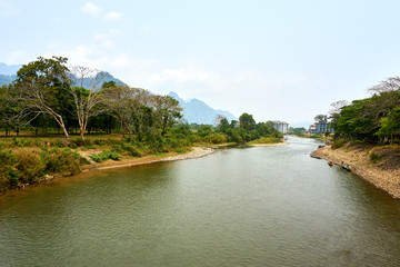 Fototapeta na wymiar Beautiful landscapes from river in Vang Vieng , Loas mountains in background