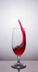 Splash red wine in glass