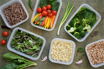  Vegan meal prep lunch box containers with quinoa, brown rice, buckwheat noodles, spinach, tomato, pepper, broccoli, savoy cabbage, lettuce, onions