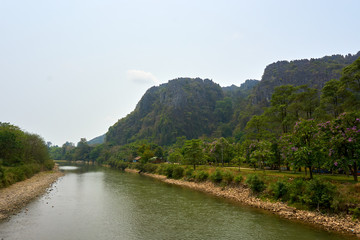 Fototapeta premium Beautiful landscapes from river in Vang Vieng , Loas mountains in background