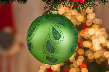 Christmas balls on a Christmas tree with light on background