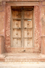 Fototapeta na wymiar old wooden door in stone wall